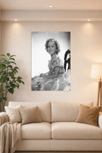 Shirley Temple in a bright living room above a beige sofa.