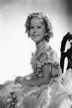 Shirley Temple poster features a black-and-white portrait of the smiling child star in a ruffled dress with curled hair.