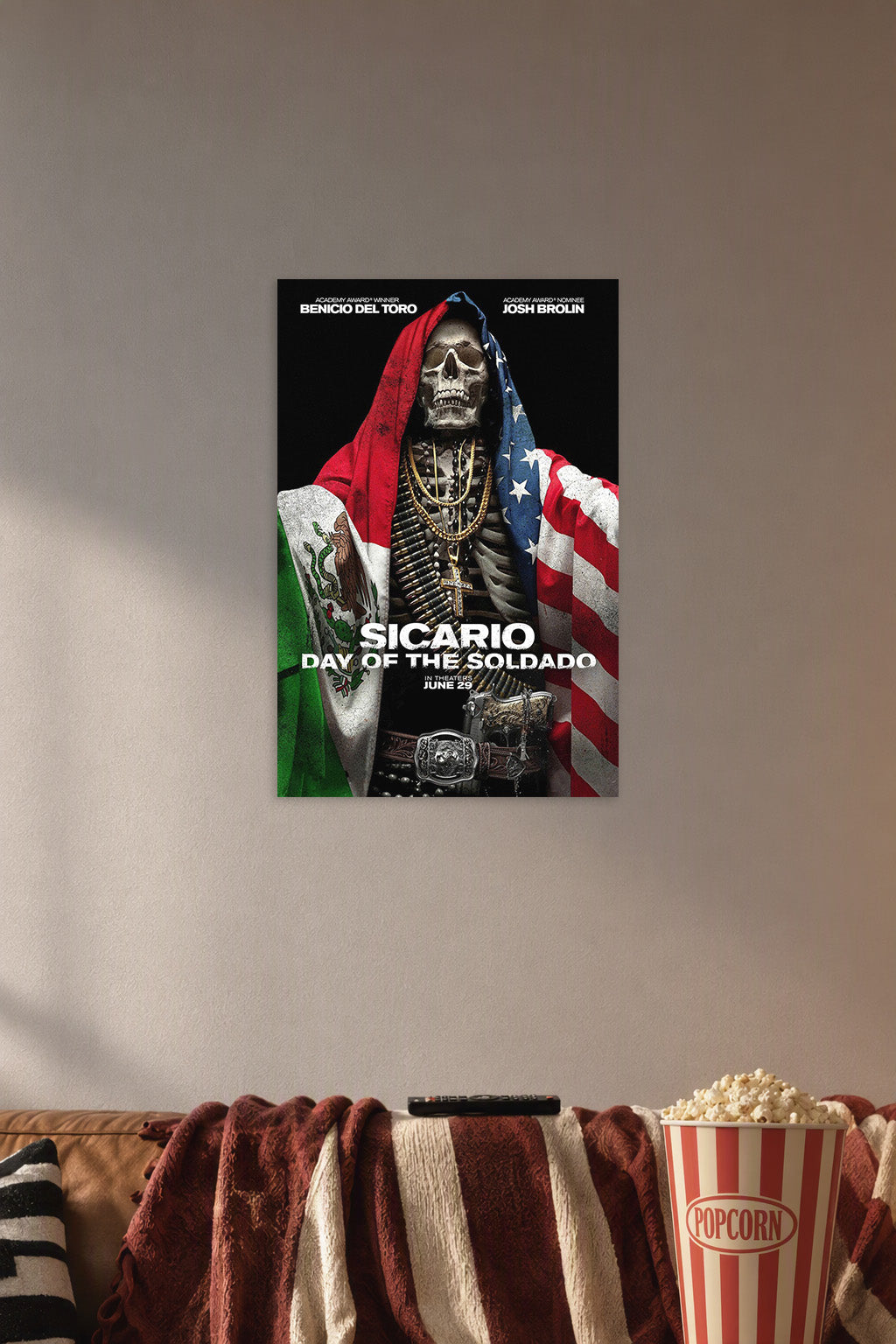Sicario Day of the Soldado Movie Poster in a cozy movie room above a brown sofa with popcorn.