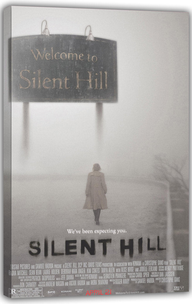 Silent Hill canvas wall art print featuring a foggy road, a woman in a beige coat, and the town welcome sign.