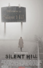 Silent Hill poster wall art print with a lone woman walking through dense fog beneath a Welcome to Silent Hill sign.