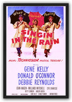 Framed Singin' in the Rain poster wall art with three raincoat-clad performers, umbrellas, red title text, and blue credits.