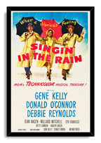 Singin' in the Rain framed wall art print with black border, rainy blue sky, yellow raincoats, umbrellas, and cast names.