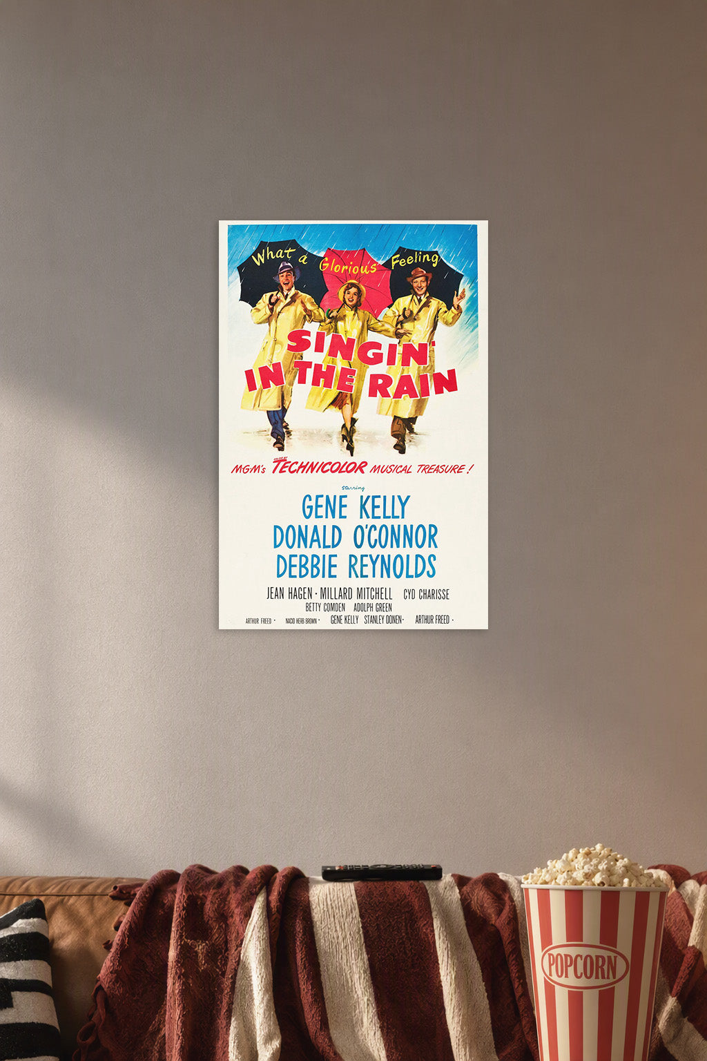 Singin' in the Rain Movie Poster in a cozy movie room above a brown sofa with popcorn.