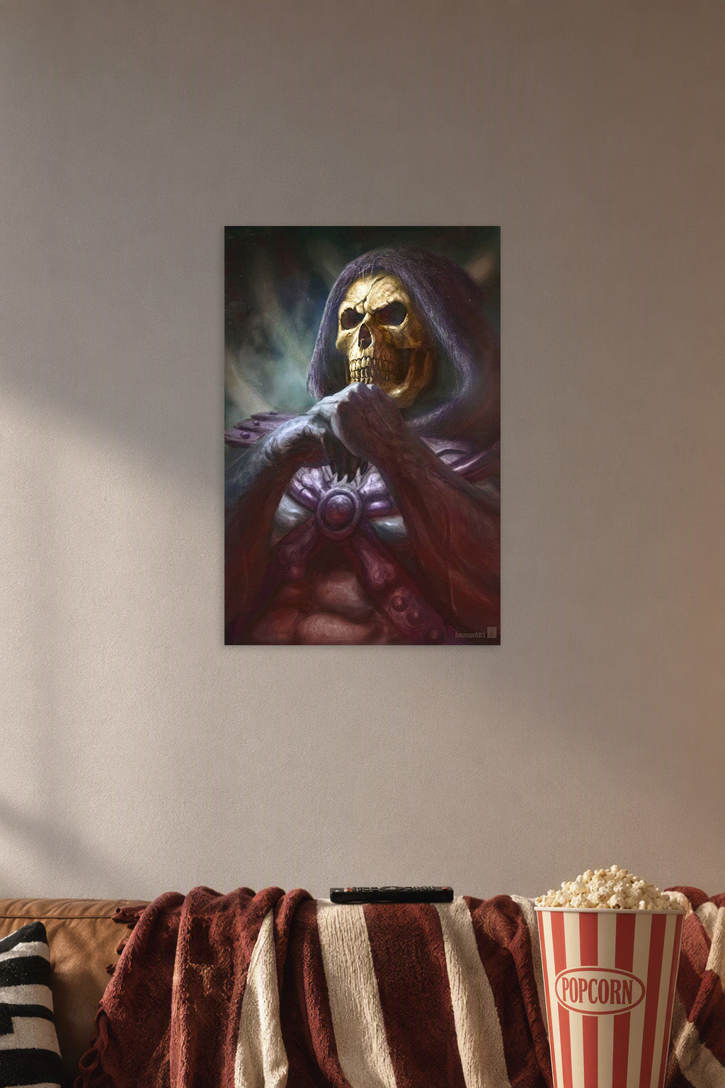 Skeletor in a cozy movie room above a brown sofa with popcorn.