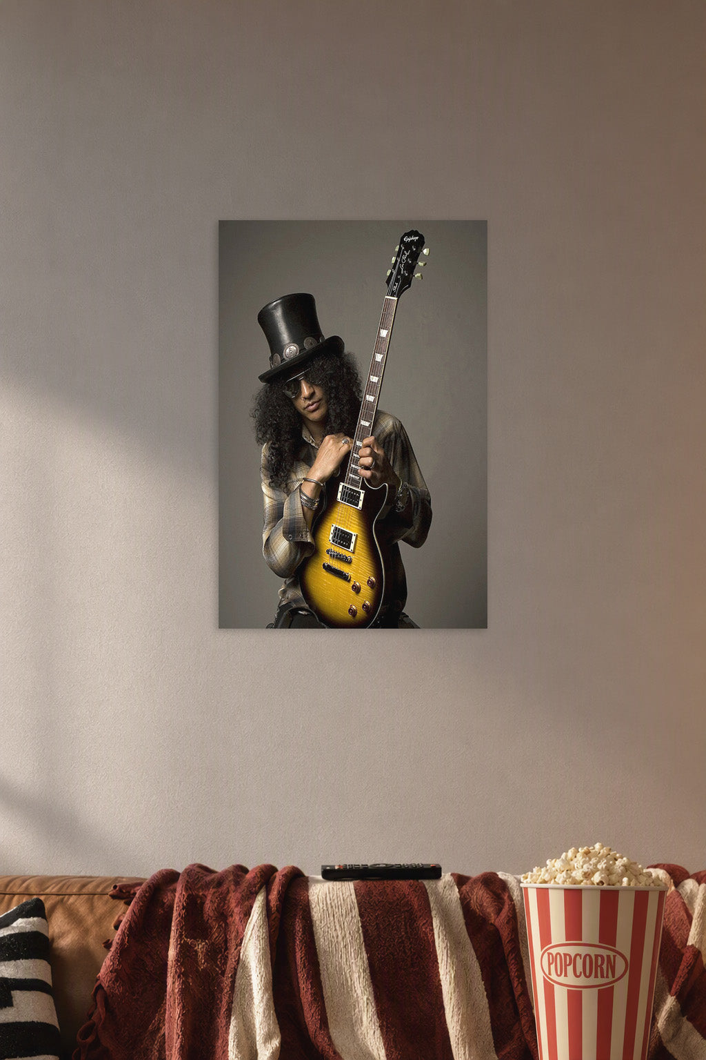 Slash in a cozy movie room above a brown sofa with popcorn.