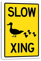Slow Duck Crossing canvas wall art print featuring black duck and duckling silhouettes, yellow sign field, and white canvas edges.