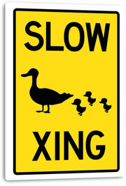 Slow Duck Crossing canvas wall art print featuring black duck and duckling silhouettes, yellow sign field, and white canvas edges.