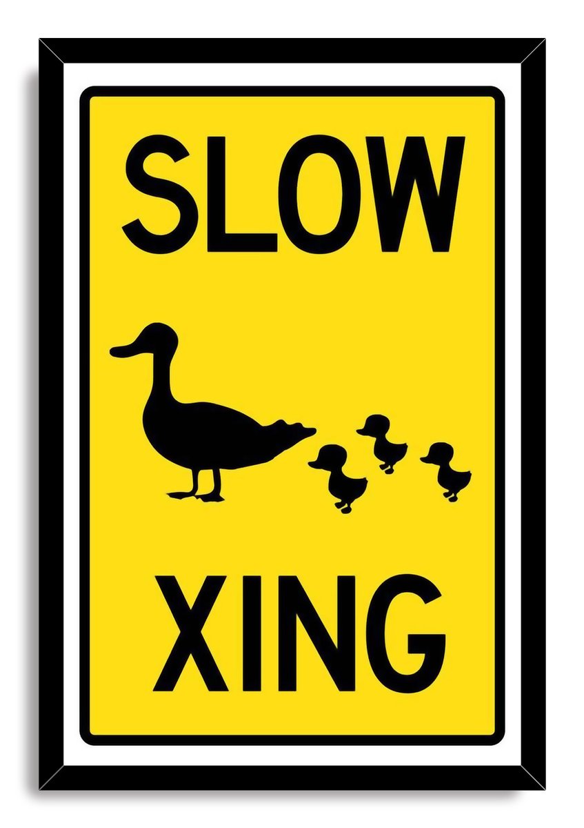 Slow Duck Crossing framed wall art print with a black frame, yellow sign design, and mother duck leading three ducklings.