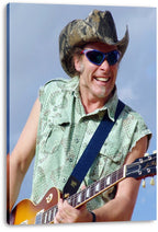 Guitarist canvas wall art print featuring a smiling man in a camouflage cowboy hat and blue sunglasses playing a sunburst electric guitar.