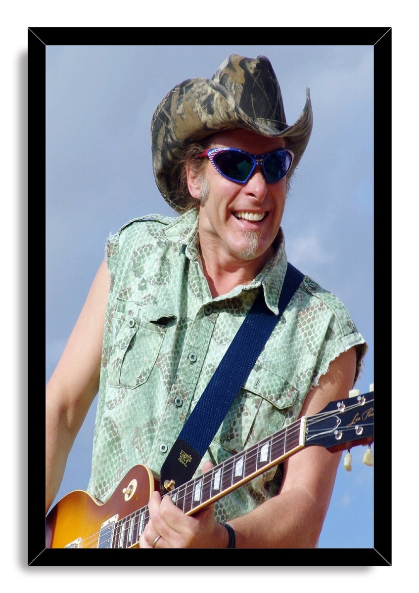 Guitarist framed wall art print featuring a smiling man in blue sunglasses and a camouflage cowboy hat playing a sunburst electric guitar.
