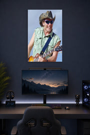 Smiling Guitarist in Cowboy Hat in a gaming desk setup above a monitor.