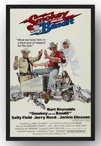 Smokey and the Bandit framed wall art print presents a sheriff, cowboy-hatted man, bride, dog, semi truck, and vehicles in a black frame.
