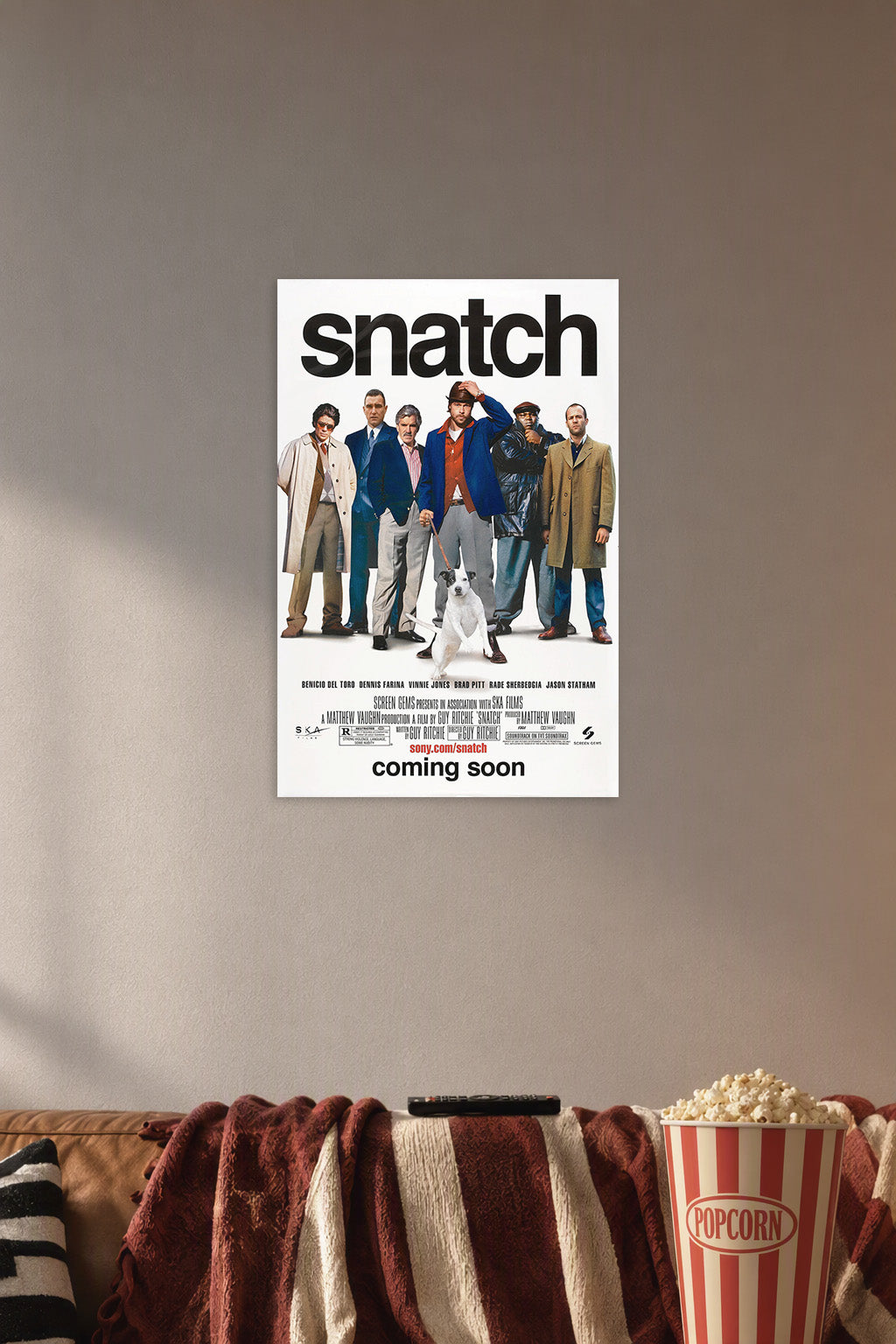 Snatch Movies in a cozy movie room above a brown sofa with popcorn.