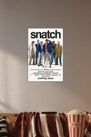 Snatch Movies in a cozy movie room above a brown sofa with popcorn.