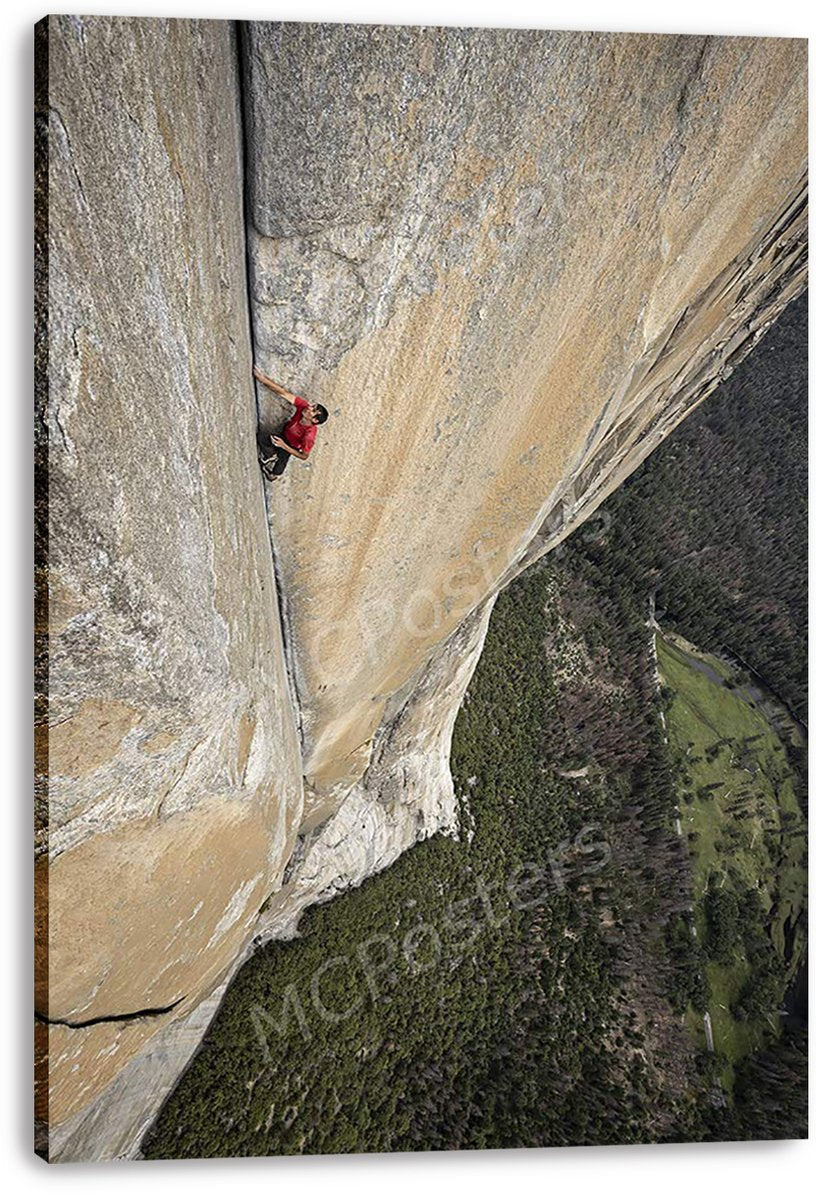 Rock climber canvas wall art print features a red-clad climber on a towering beige rock face over dense woodland.
