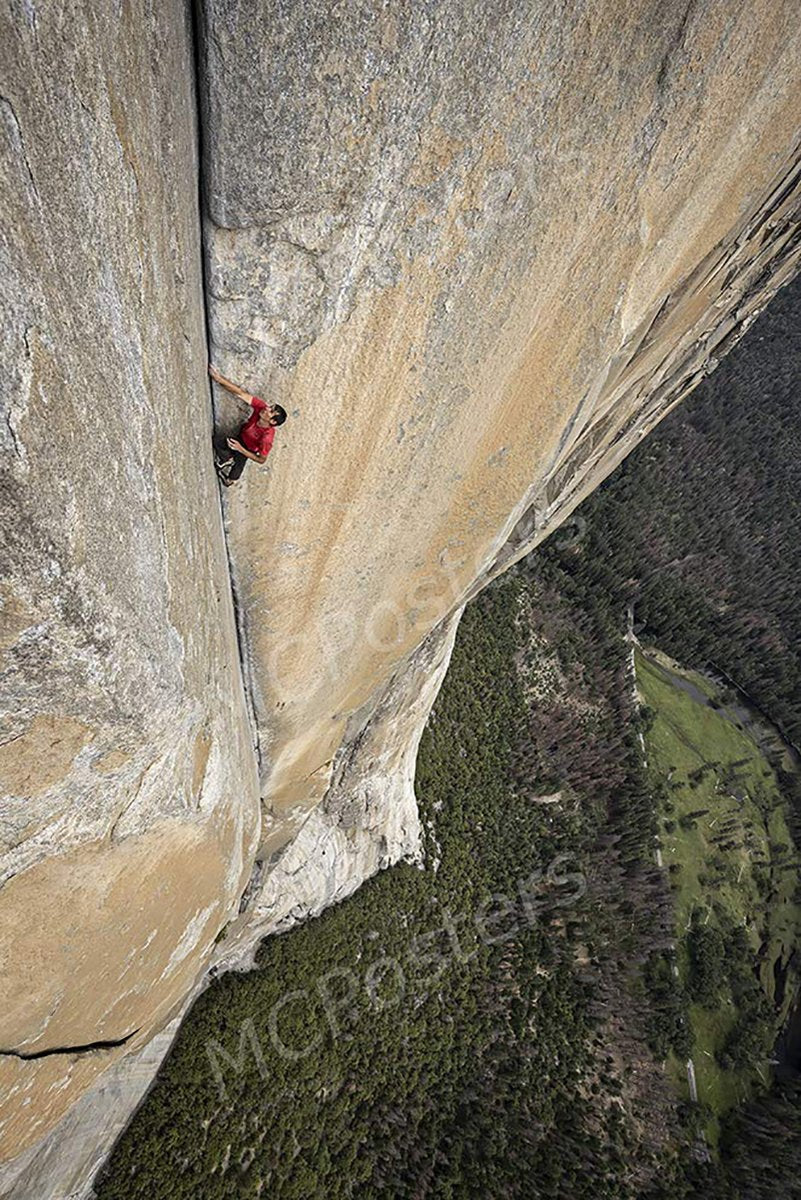 Rock climber wall art print depicts a person in a red shirt ascending a sheer tan cliff above a green forest valley.