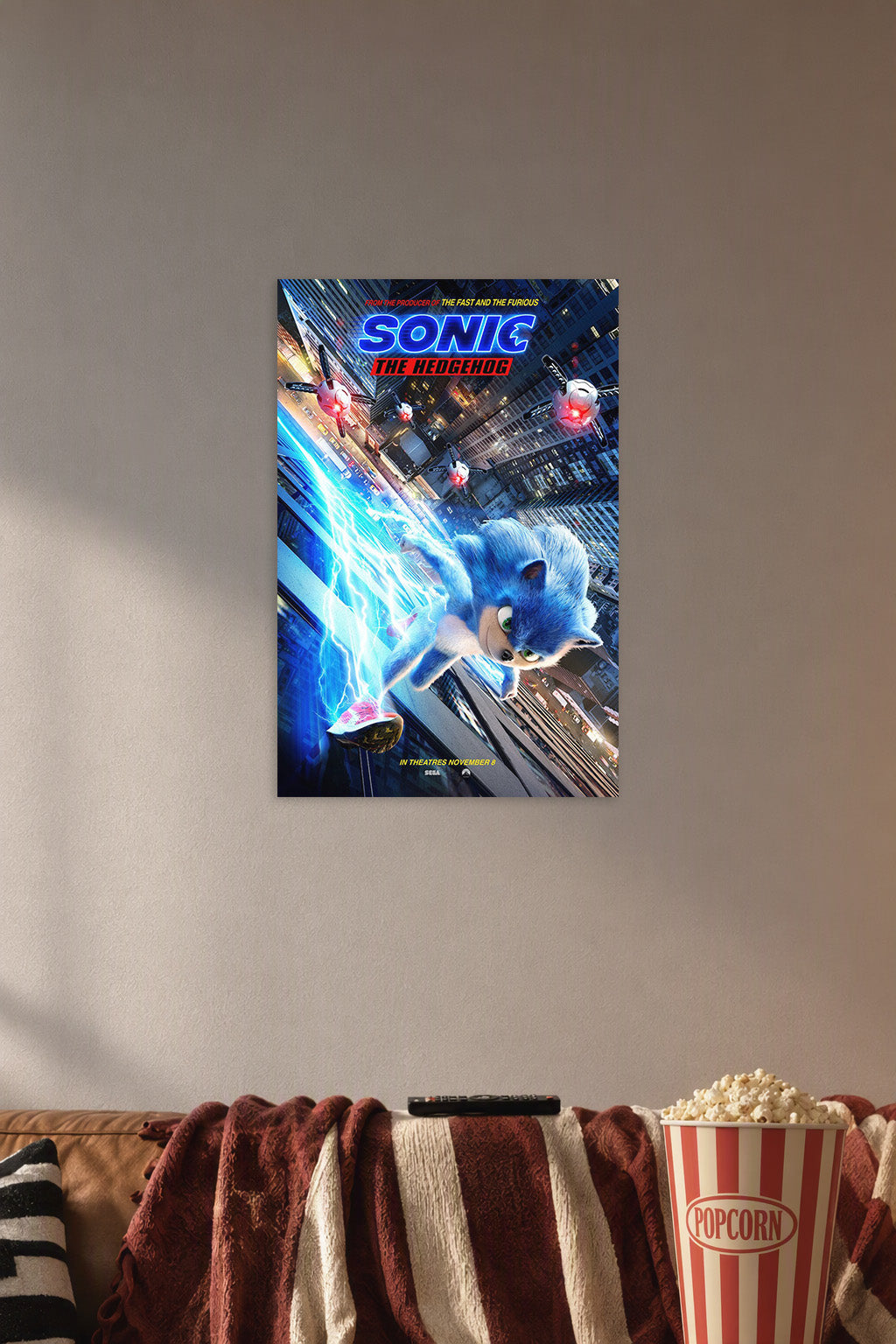 Sonic The Hedgehog in a cozy movie room above a brown sofa with popcorn.