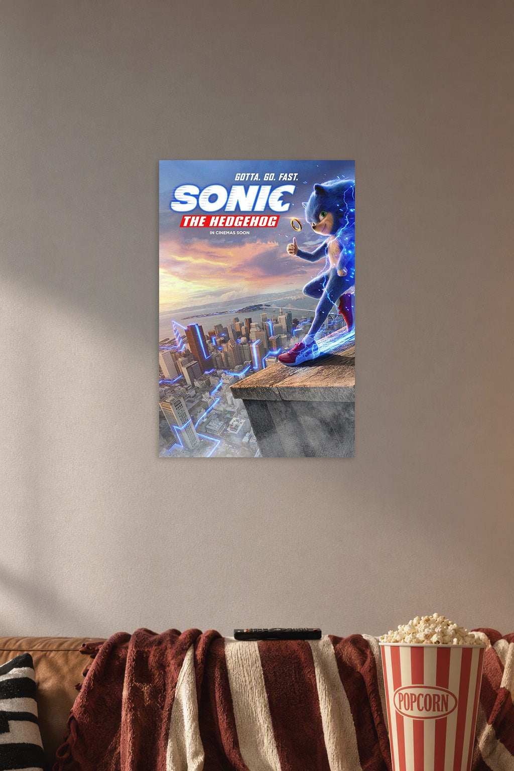 Sonic the Hedgehog Movie in a cozy movie room above a brown sofa with popcorn.