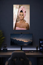 Sophia Loren in a gaming desk setup above a monitor.