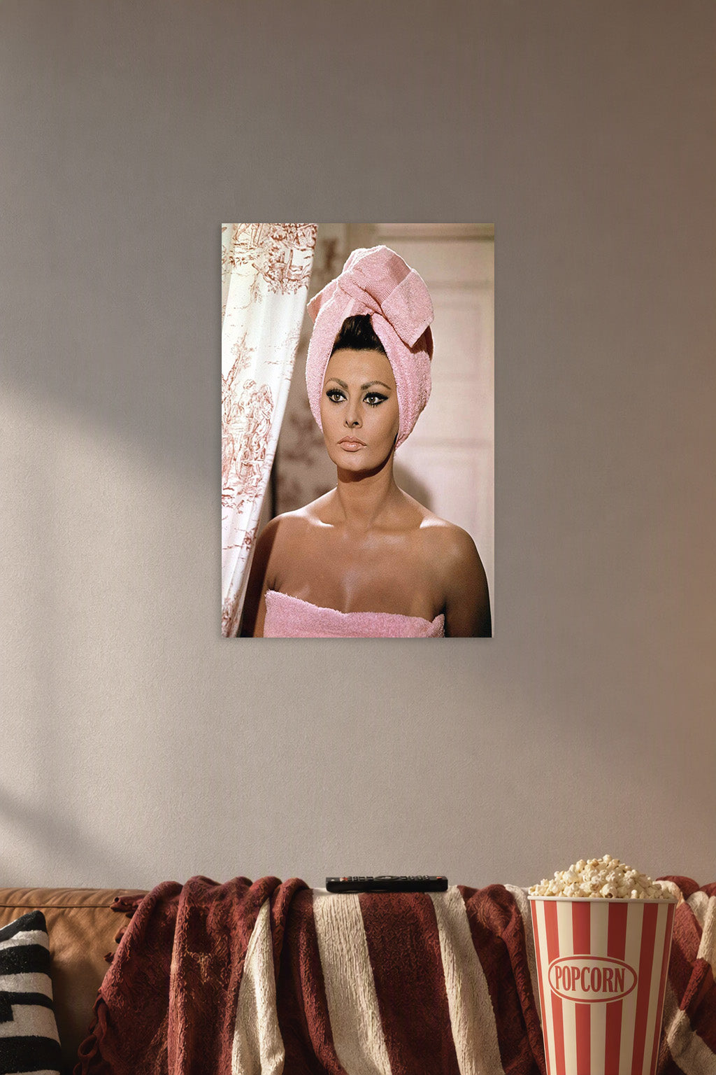 Sophia Loren in a cozy movie room above a brown sofa with popcorn.