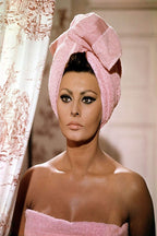 Sophia Loren poster portrait in a pink towel turban and wrap beside a patterned shower curtain.