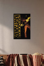 Soundgarden in a cozy movie room above a brown sofa with popcorn.