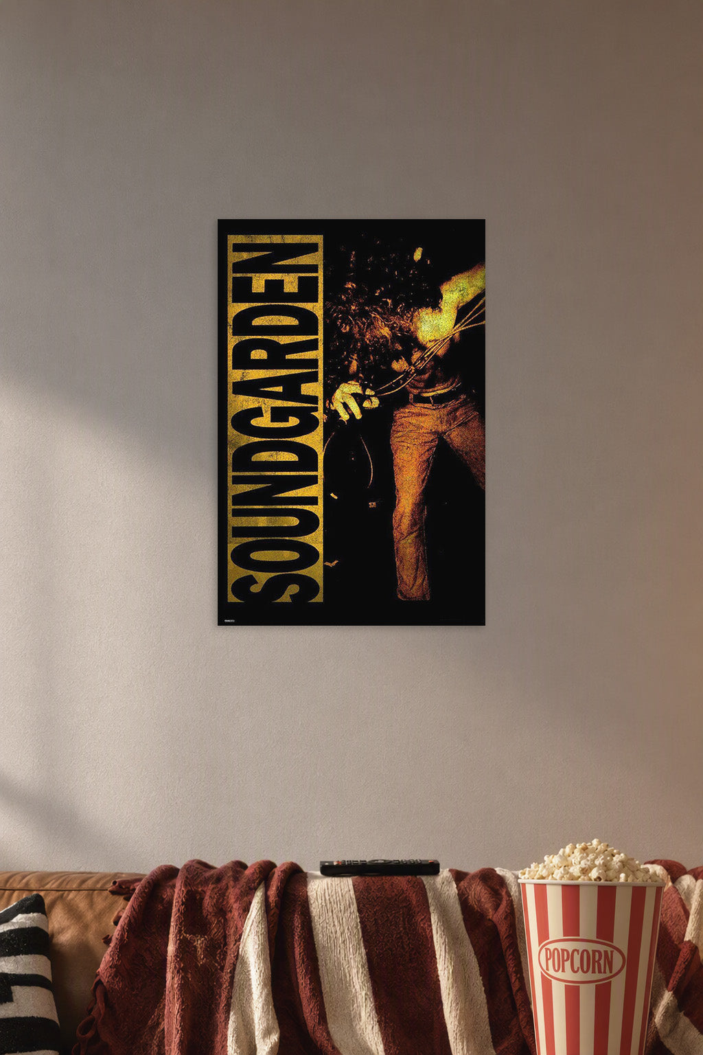 Soundgarden in a cozy movie room above a brown sofa with popcorn.