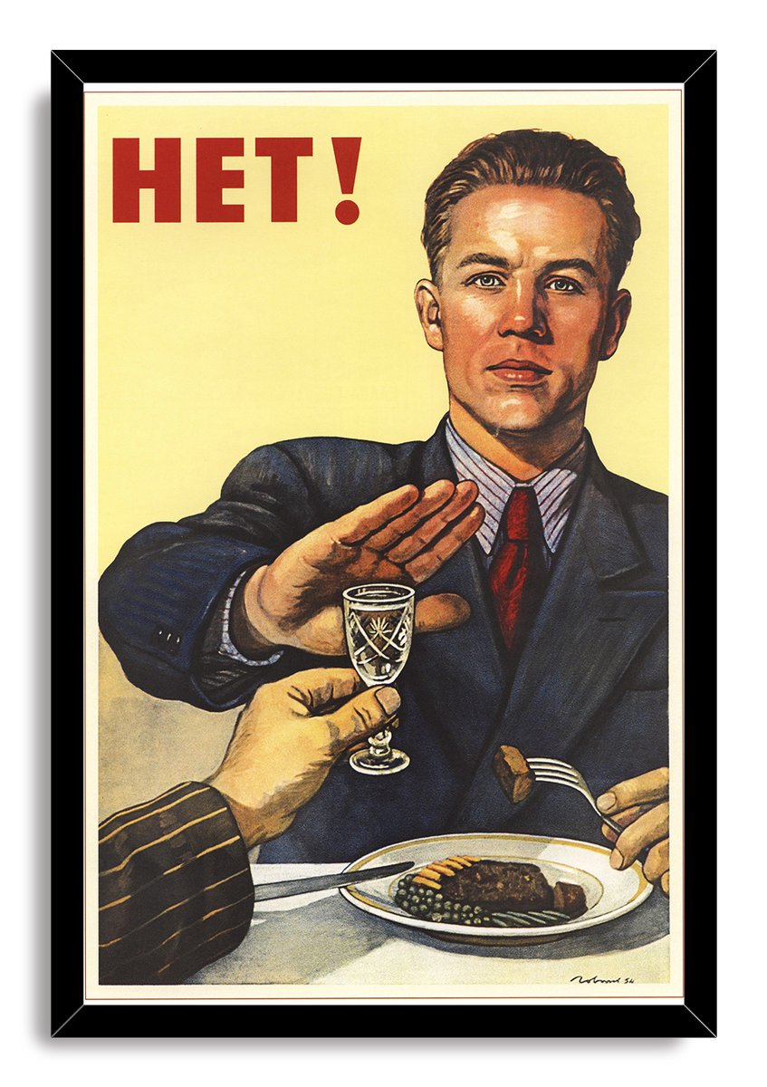 Framed Soviet anti-alcohol wall art print with HET! lettering, a serious man refusing a drink beside steak, peas, and cutlery.
