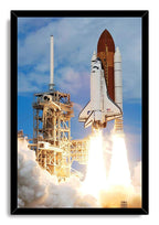 Space Shuttle Discovery framed wall art print features the shuttle rising past a launch tower amid brilliant flames and billowing clouds of smoke.