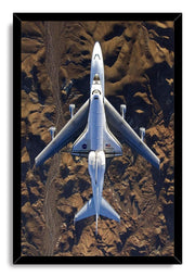Space Shuttle Endeavour framed wall art print features the white shuttle atop its carrier aircraft over a textured desert landscape.