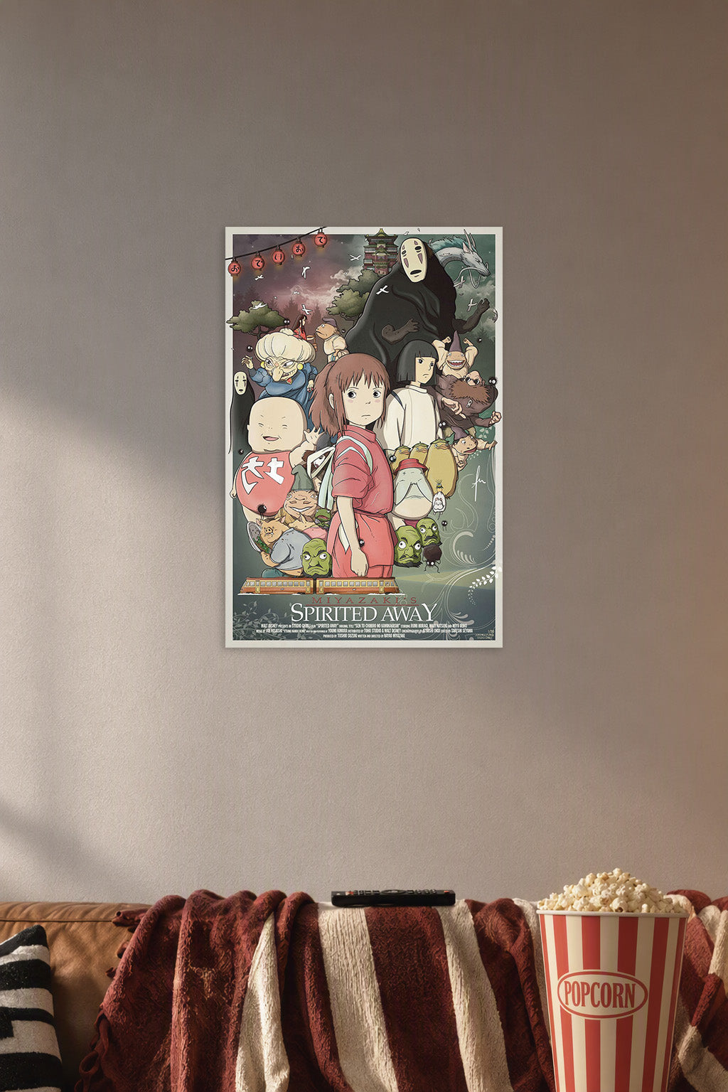 Spirited Away in a cozy movie room above a brown sofa with popcorn.