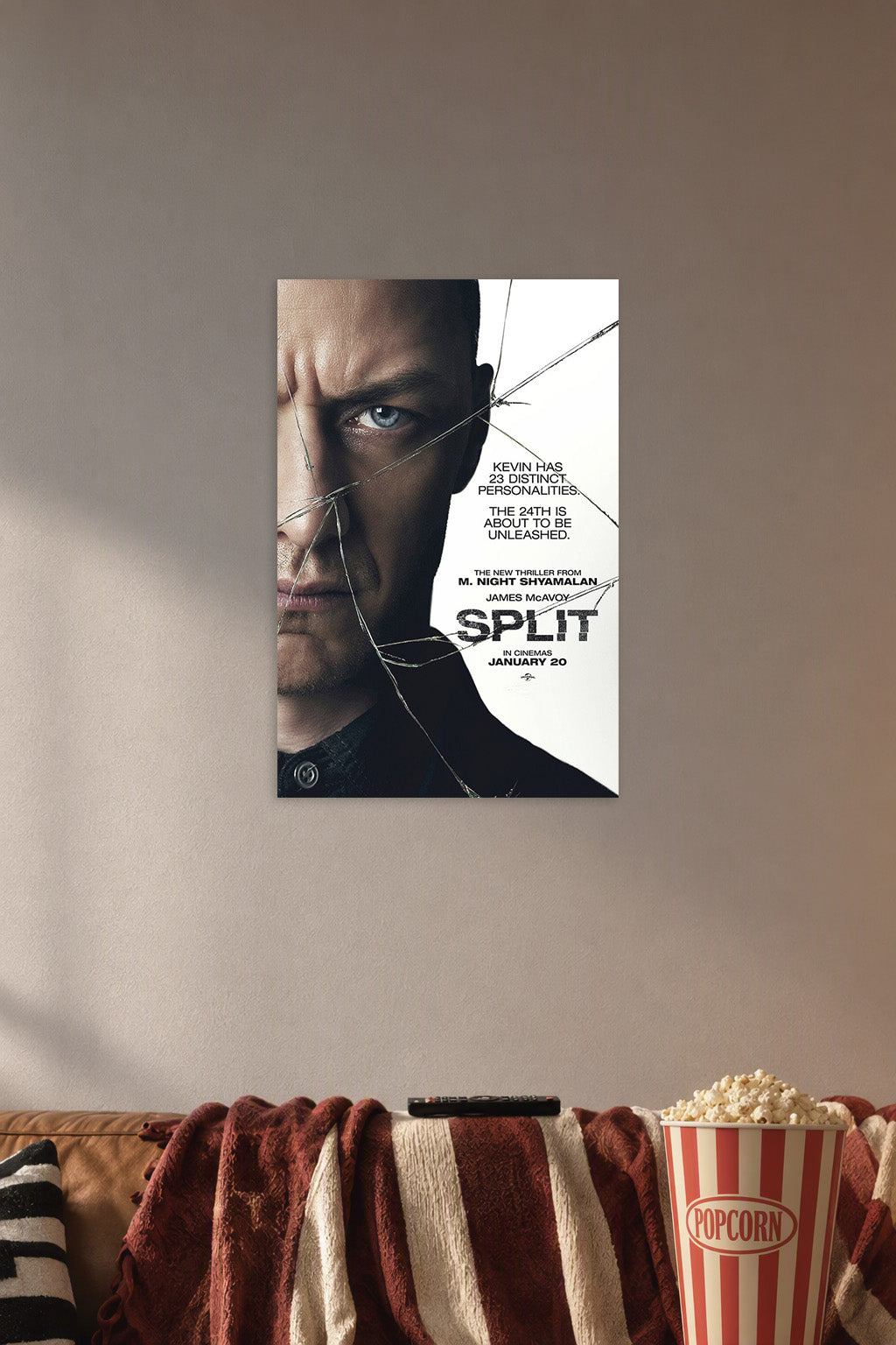 Split Movie Poster in a cozy movie room above a brown sofa with popcorn.