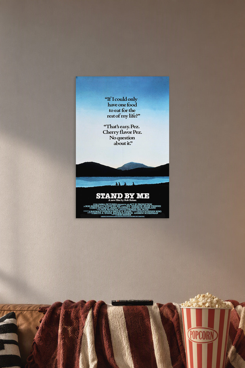 Stand By Me Movie Poster in a cozy movie room above a brown sofa with popcorn.