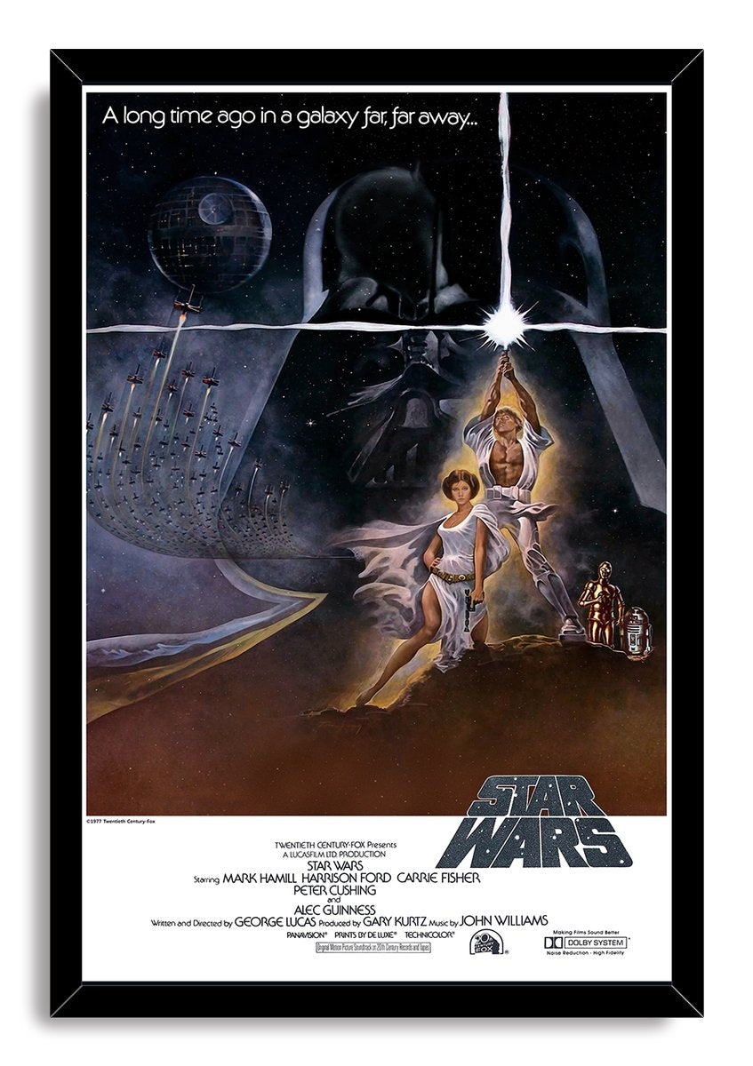 Star Wars poster in a black frame featuring Luke's glowing lightsaber, Leia, Darth Vader, the Death Star, and flying spacecraft.