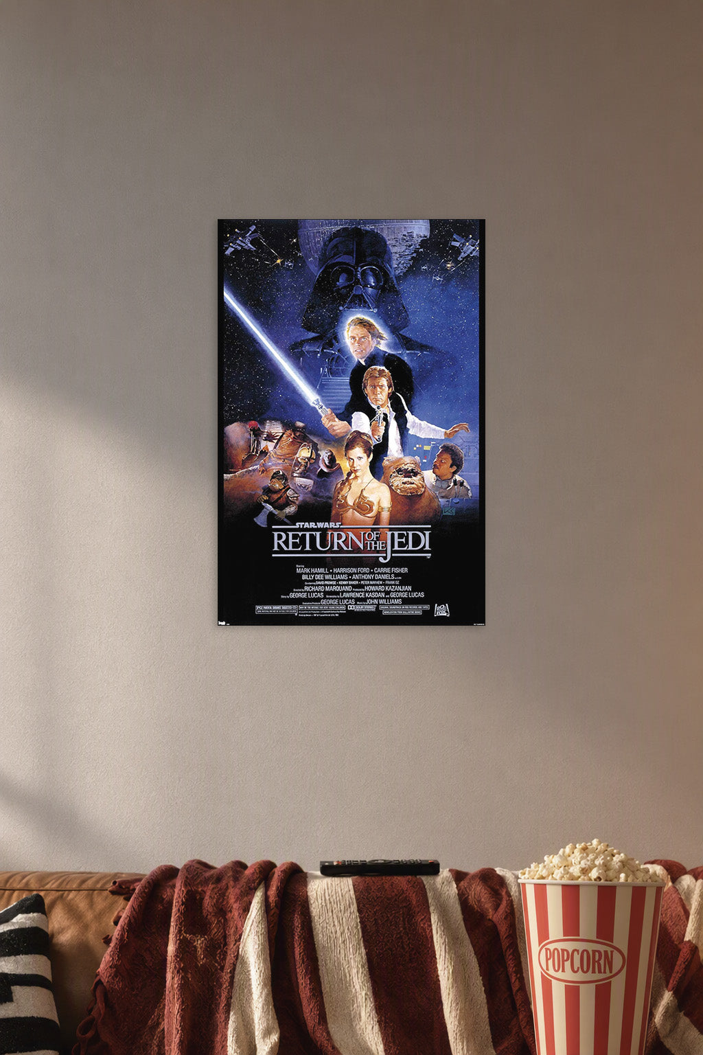 Star Wars: Return Of The Jedi Movie in a cozy movie room above a brown sofa with popcorn.