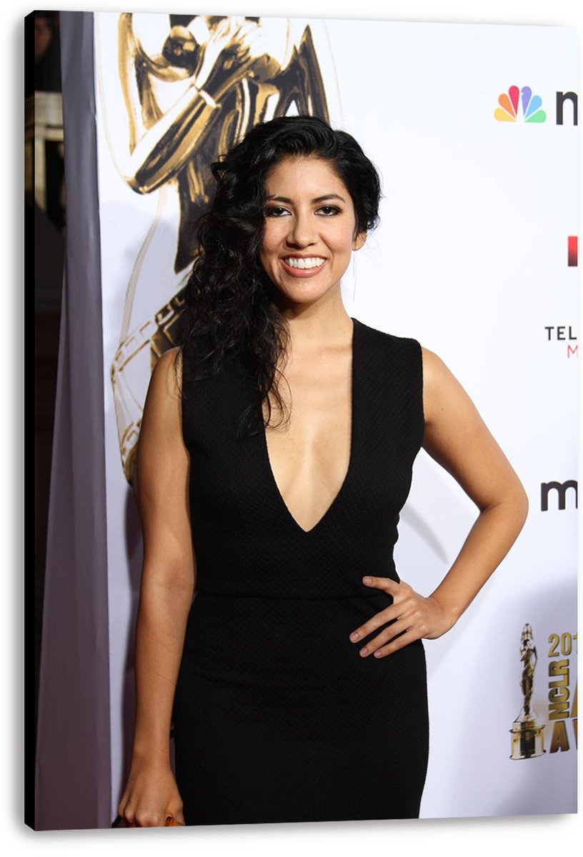 Stephanie Beatriz canvas wall art print displays her smiling in a black dress against a white backdrop, with the wrapped canvas edge visible.