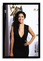 Stephanie Beatriz framed wall art print presents her smiling in a black dress at an awards-event backdrop, enclosed by a glossy black frame.