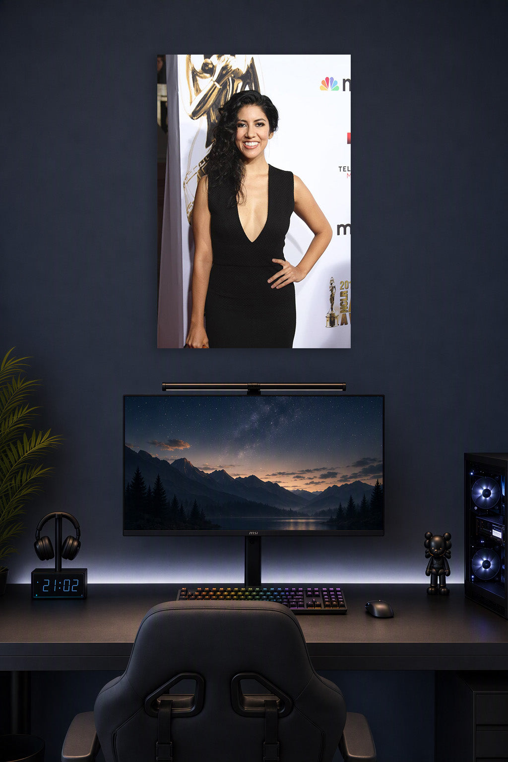 Stephanie Beatriz in a gaming desk setup above a monitor.