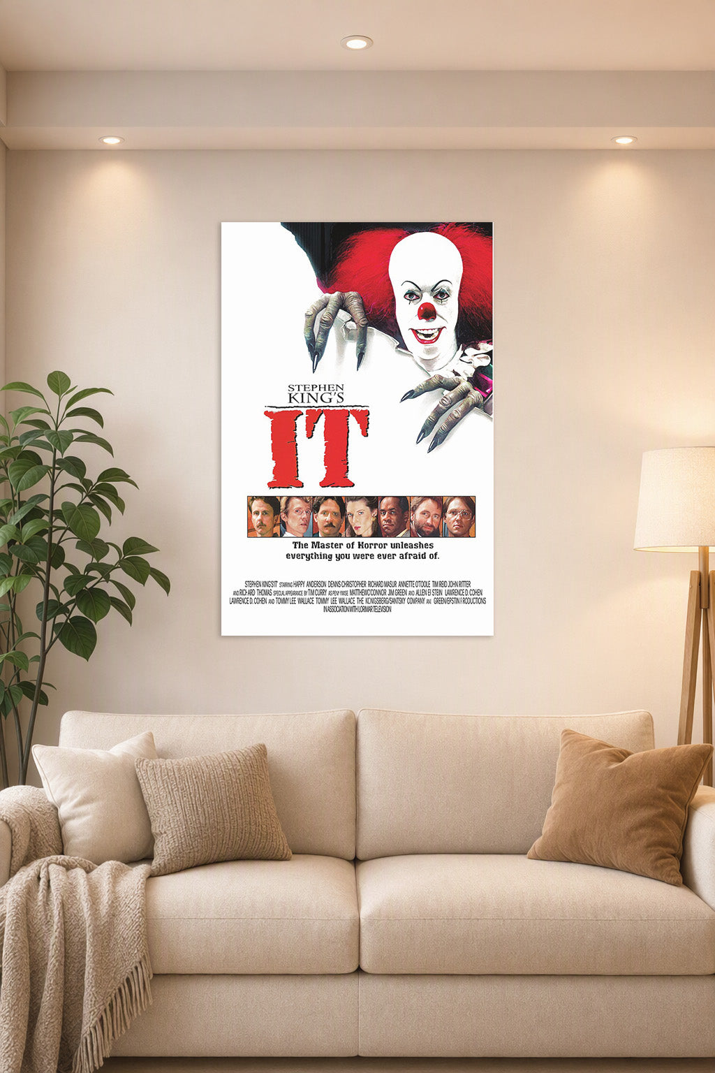 Stephen King's IT Pennywise in a bright living room above a beige sofa.