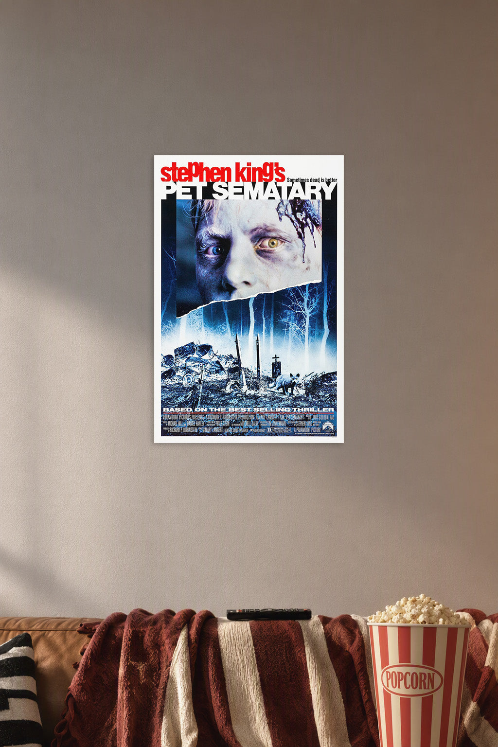 Stephen King's Pet Sematary Movie Poster in a cozy movie room above a brown sofa with popcorn.
