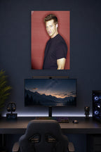 Steve Burton in a gaming desk setup above a monitor.