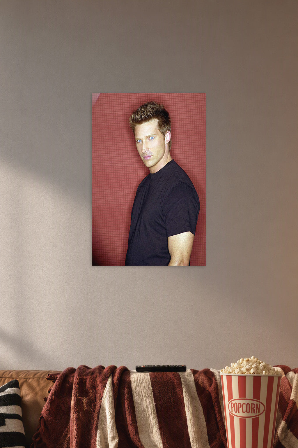 Steve Burton in a cozy movie room above a brown sofa with popcorn.
