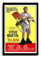 The Jerk framed wall art print features Steve Martin carrying a chair and appliances against a yellow field with red credits.