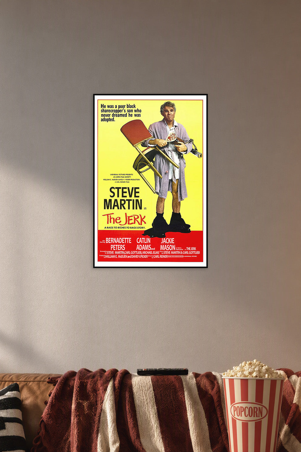Steve Martin The Jerk Movie Poster in a cozy movie room above a brown sofa with popcorn.