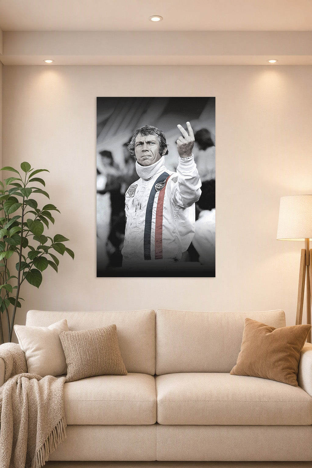 Steve McQueen in a bright living room above a beige sofa.