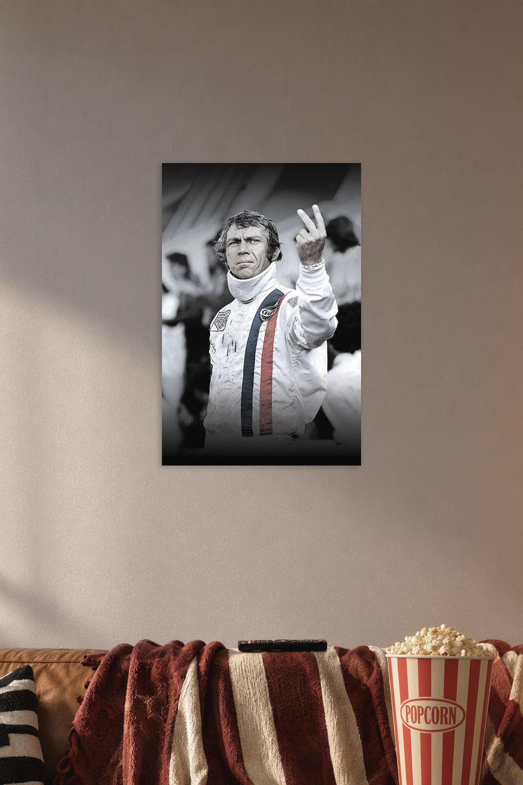 Steve McQueen in a cozy movie room above a brown sofa with popcorn.
