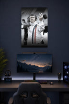 Steve McQueen in a gaming desk setup above a monitor.