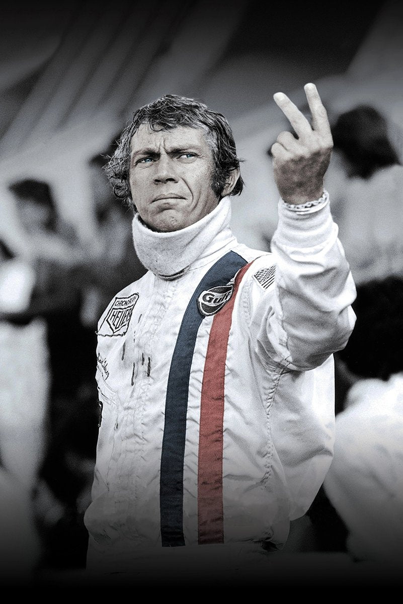Steve McQueen wall art print portrays the racing driver in a white suit raising two fingers, with blue and red stripes.