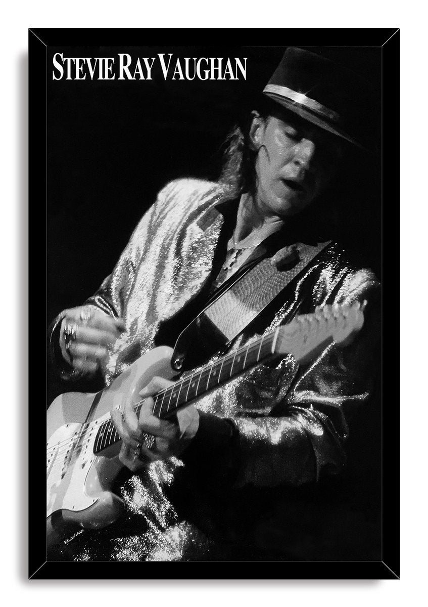Stevie Ray Vaughan framed wall art print presents a black-and-white guitarist portrait, black hat, electric guitar, and bold name lettering.